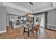 Open dining and kitchen space with pool view through glass doors, hardwood floors, and modern light fixture at 613 Daniels Ave, Orlando, FL 32801