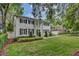 Beautiful two-story home with a manicured front lawn and mature trees providing shade at 613 Daniels Ave, Orlando, FL 32801