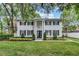 Stunning two-story home with elegant white columns, lush landscaping and black shutters at 613 Daniels Ave, Orlando, FL 32801