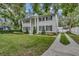 Charming two-story home with black shutters, manicured lawn, and gated driveway at 613 Daniels Ave, Orlando, FL 32801