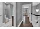 Hallway with dark wood floors and a bathroom with a shower and toilet at 613 Daniels Ave, Orlando, FL 32801
