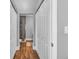 Hallway with linen closet doors and bathroom shower in background, showing tile walls at 613 Daniels Ave, Orlando, FL 32801