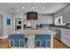 Bright kitchen with a center island, stainless steel appliances, and modern light fixture above island at 613 Daniels Ave, Orlando, FL 32801