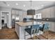Modern kitchen with stainless steel appliances, a granite island with bar seating and grey cabinets at 613 Daniels Ave, Orlando, FL 32801