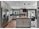 Bright kitchen with stainless steel appliances, a center island with barstool seating, and modern fixtures at 613 Daniels Ave, Orlando, FL 32801
