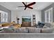 Bright living room with a ceiling fan, window shutters, and comfortable seating arrangements at 613 Daniels Ave, Orlando, FL 32801