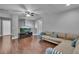 Open-concept living room with neutral paint, dark floors, and a comfortable sectional sofa at 613 Daniels Ave, Orlando, FL 32801