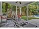 Covered patio with an outdoor grilling area, bar seating, and lounge seating near pool at 613 Daniels Ave, Orlando, FL 32801