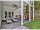 Outdoor covered patio with ceiling fan, grill, bar seating and lounge chairs at 613 Daniels Ave, Orlando, FL 32801