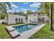 Sparkling pool with separate hot tub surrounded by lush landscaping and a two-story house at 613 Daniels Ave, Orlando, FL 32801