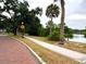 A paved sidewalk lines a street with mature trees at 613 Daniels Ave, Orlando, FL 32801