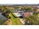 A gorgeous aerial view of a pool, clubhouse, and recreational area bordered by mature trees and water at 6301 Parson Brown Dr, Orlando, FL 32819