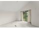 Clean, well-lit empty bedroom with neutral walls and large sliding glass door at 6301 Parson Brown Dr, Orlando, FL 32819