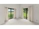Empty room, two sliding glass doors to outside at 6301 Parson Brown Dr, Orlando, FL 32819