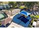 Aerial view of a playground with a blue awning, slides, swings, and a nearby basketball court and covered picnic area at 6301 Parson Brown Dr, Orlando, FL 32819