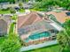 Aerial view of the home features a screened-in pool, spa, and well-maintained backyard at 677 Cheoy Lee Cir, Winter Springs, FL 32708