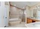 Elegant bathroom featuring tiled walls, tub, shower, and vanity with dual sinks at 677 Cheoy Lee Cir, Winter Springs, FL 32708