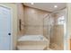 Bathroom featuring a soaking tub, glass enclosed shower and neutral colored ceramic tile surround at 677 Cheoy Lee Cir, Winter Springs, FL 32708