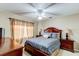 Cozy bedroom with large window, ceiling fan, and stylish furniture at 677 Cheoy Lee Cir, Winter Springs, FL 32708