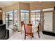Dining room features a round table with four chairs and natural lighting from the screened-in pool area at 677 Cheoy Lee Cir, Winter Springs, FL 32708