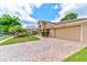Exterior of the house showcasing the manicured landscaping, long driveway and 2-car garage at 677 Cheoy Lee Cir, Winter Springs, FL 32708