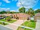 A charming single-story home with a well-maintained yard, brick driveway, and a two-car garage at 677 Cheoy Lee Cir, Winter Springs, FL 32708
