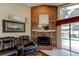 Living room featuring a brick fireplace with access to outdoor pool and comfortable seating at 677 Cheoy Lee Cir, Winter Springs, FL 32708