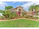 Beautiful single-Gathering home with a well-manicured lawn, lush landscaping, and a charming exterior at 677 Cheoy Lee Cir, Winter Springs, FL 32708