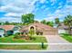 Inviting single-story house showcasing lush lawn and mature trees at 677 Cheoy Lee Cir, Winter Springs, FL 32708