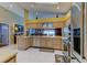 Bright kitchen with updated appliances, ample counter space, and a view of the living area and backyard at 677 Cheoy Lee Cir, Winter Springs, FL 32708
