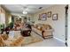Elegant living room featuring a large mirror wall, plush sofas, and neutral color scheme with plenty of natural light at 677 Cheoy Lee Cir, Winter Springs, FL 32708