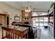 Spacious living room features a brick fireplace, ceiling fan, and sliding glass doors to the pool area at 677 Cheoy Lee Cir, Winter Springs, FL 32708