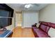 Living room featuring hardwood floors, a comfortable red couch and large closet at 677 Cheoy Lee Cir, Winter Springs, FL 32708