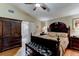 Comfortable main bedroom with hardwood floors, a large bed, and an en-suite bathroom at 677 Cheoy Lee Cir, Winter Springs, FL 32708
