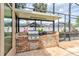 Enclosed outdoor kitchen features a brick grill with a stainless steel gas cooktop and countertop for food preparation at 677 Cheoy Lee Cir, Winter Springs, FL 32708