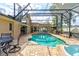 Aerial view of the private screened pool with plenty of lounge space and an outdoor kitchen at 677 Cheoy Lee Cir, Winter Springs, FL 32708