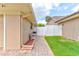 Property side yard showcases paver pathway, white fence, and green grass, ideal for outdoor activities at 677 Cheoy Lee Cir, Winter Springs, FL 32708