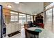 Sunroom features multiple windows, tile flooring, and a ceiling fan for ample natural light at 677 Cheoy Lee Cir, Winter Springs, FL 32708