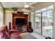 Sunroom featuring multiple windows, tile flooring, a ceiling fan, and a mounted television at 677 Cheoy Lee Cir, Winter Springs, FL 32708