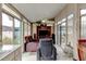 Sunroom featuring multiple windows, tile flooring, a ceiling fan and comfortable recliners at 677 Cheoy Lee Cir, Winter Springs, FL 32708