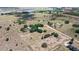 Expansive aerial view of the property featuring multiple dwellings, fenced pastures, and mature trees at 7823 Baron Ave, Howey In The Hills, FL 34737