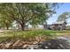 Inviting backyard with well-manicured lawn, mature trees, and charming sheds at 7823 Baron Ave, Howey In The Hills, FL 34737