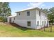 Image shows home's rear exterior elevation with two stories and fenced area in yard at 7823 Baron Ave, Howey In The Hills, FL 34737