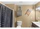 This is a bathroom with a black and white shower curtain and a vanity at 7823 Baron Ave, Howey In The Hills, FL 34737