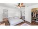Bedroom with white walls, wood-look floors, and an en suite bathroom with a shower at 7823 Baron Ave, Howey In The Hills, FL 34737