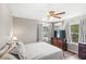 Cozy bedroom featuring hardwood floors, large windows, and neutral décor at 7823 Baron Ave, Howey In The Hills, FL 34737