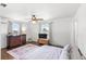 Bright bedroom featuring hardwood floors, two windows, and a scenic view at 7823 Baron Ave, Howey In The Hills, FL 34737