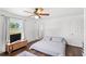 Bright bedroom featuring hardwood floors, ceiling fan, natural light and white walls at 7823 Baron Ave, Howey In The Hills, FL 34737