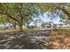 Spacious driveway leading to a charming home with a two-car carport at 7823 Baron Ave, Howey In The Hills, FL 34737