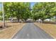 Long driveway leading to a beautiful home surrounded by trees and lush landscaping at 7823 Baron Ave, Howey In The Hills, FL 34737